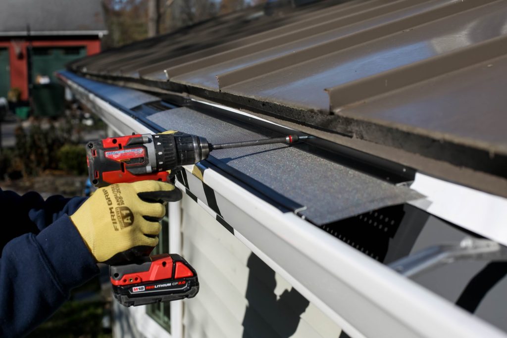 Fastening gutter guards in place with a drill